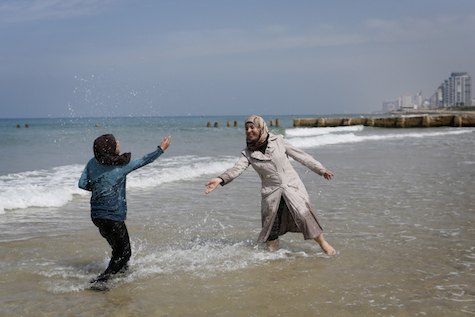 Arab women from Bethelehem play on the beach in Tel Aviv, March 23, 2014