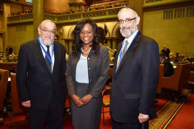 Agudath Israel’s Rabbi David Zwiebel (r) and Rabbi Shmuel Leftkowitz with Assemblymember Bichotte just days after the controversy over the radio show. The rabbis were in Albany to discuss a better tax credit bill.