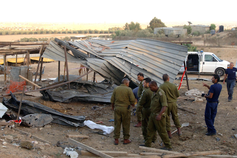 IDF officers examine the remains of a shed in Beer Sheva that was hit by a Grad rocket, July 14, 2014.