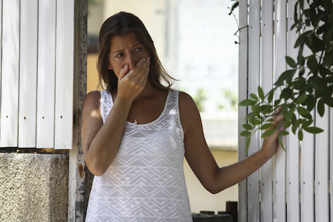 A woman examines the damage from a Grad rocket in Ashdod, 