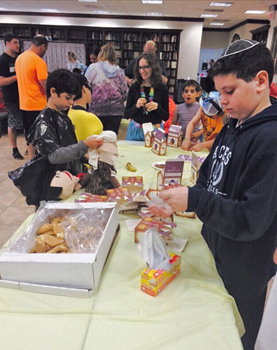 Volunteers packing Purim baskets at Chabad of South Broward.