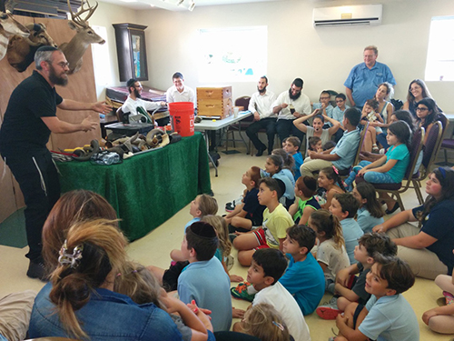 Children participate in shofar factory.