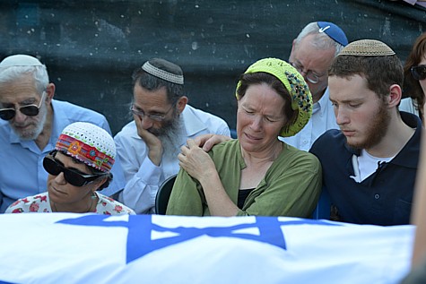 Mother of Naftali Frenkel, Rachel Frenkel, seen crying over the body of her son, during the joint funeral for the three murdered Jewish teens, in the Modiin cemetery, on July 1, 2014.