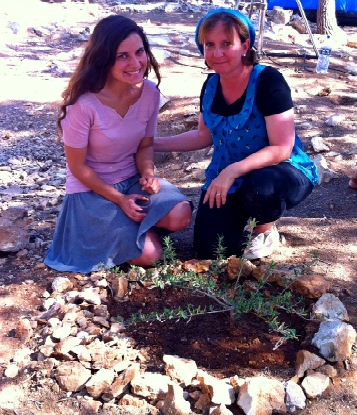 Ruth Lieberman and her daughter, Merav, plant a tree in Eyal Yifrach's memory at the new site created to honor the boys, Givat Oz v'Gaon.