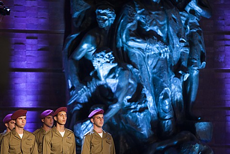 Israeli soldiers stand below a monument as they attend a ceremony at the Yad Vashem Holocaust Memorial Museum in Jerusalem, as Israel marks the annual Holocaust Remembrance Day. April 27, 2014. Photo by Yonatan Sindel/Flash90