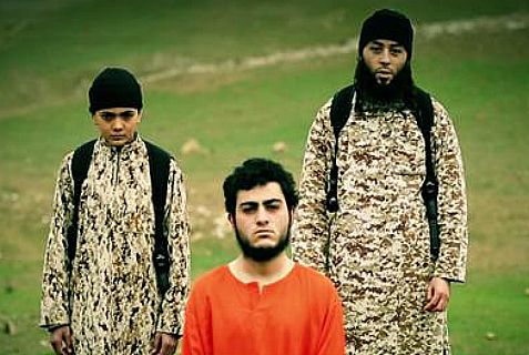 ISIS child stands next to one of his "teachers" before executing an Arab from Jerusalem.