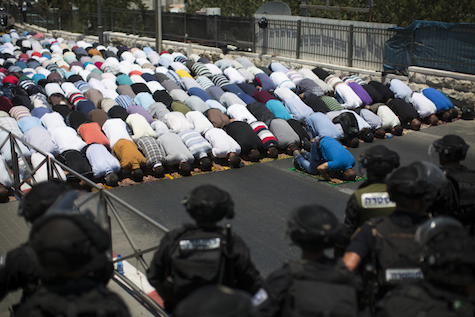 Israeli police protect Muslims at prayer on first Friday of Ramadan. Somehow, the photo never made it to the international media. 