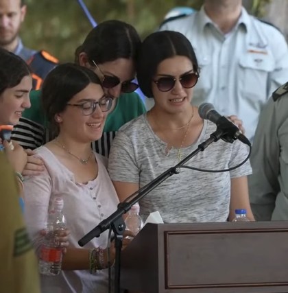 Children eulogizing their father, a reservist, who was killed in Gaza